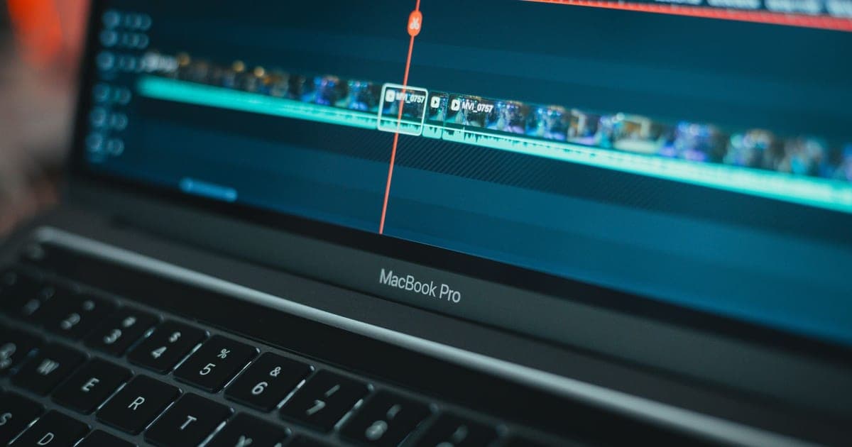 A laptop screen showing a video editing timeline with clips arranged along it