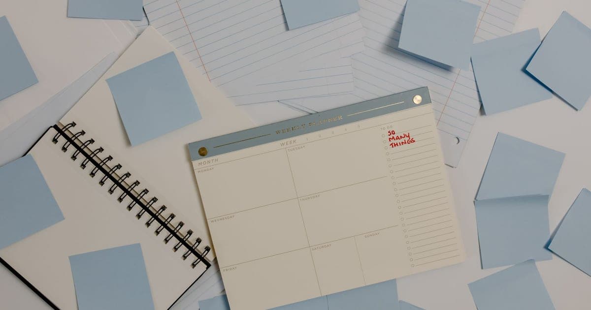 Blue sticky notes laid out in rows across a sheet of white paper