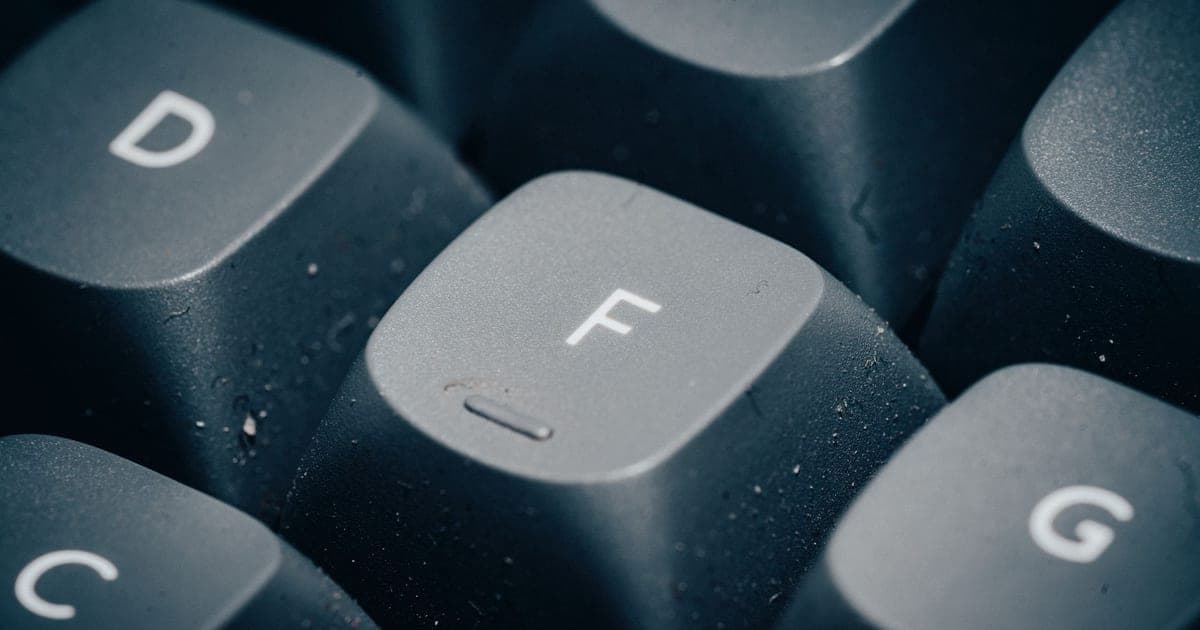 A close-up of the D, F and G keycaps on a dark mechanical keyboard, showing the shaped profile and texture of each cap